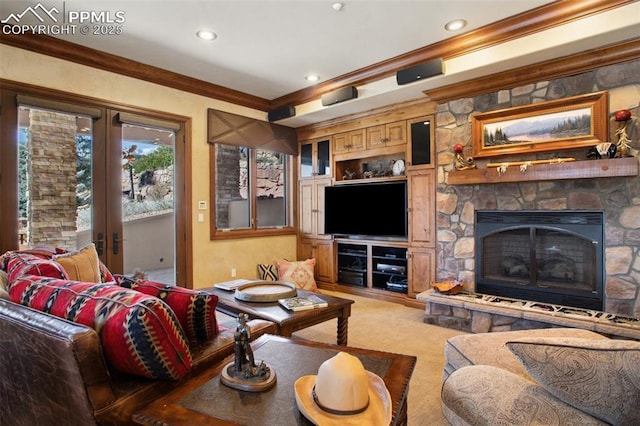 carpeted living room with recessed lighting, a fireplace, ornamental molding, and french doors