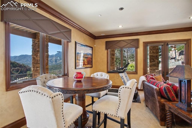 dining space featuring carpet floors, french doors, recessed lighting, ornamental molding, and a mountain view