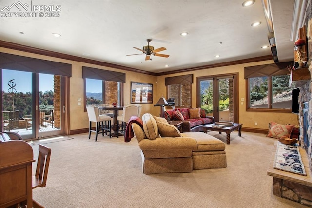 living area with light carpet, french doors, and ornamental molding