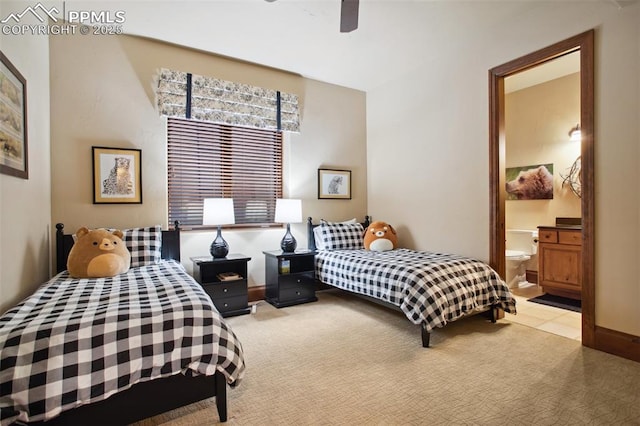 bedroom featuring a ceiling fan, carpet, baseboards, and ensuite bath