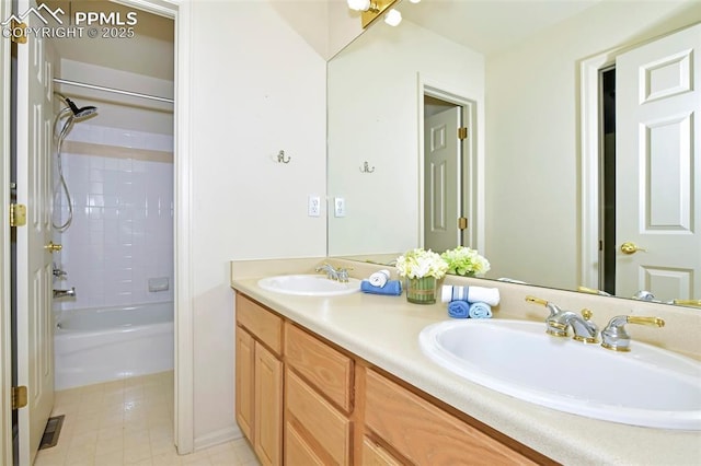 bathroom featuring bathtub / shower combination, double vanity, visible vents, and a sink