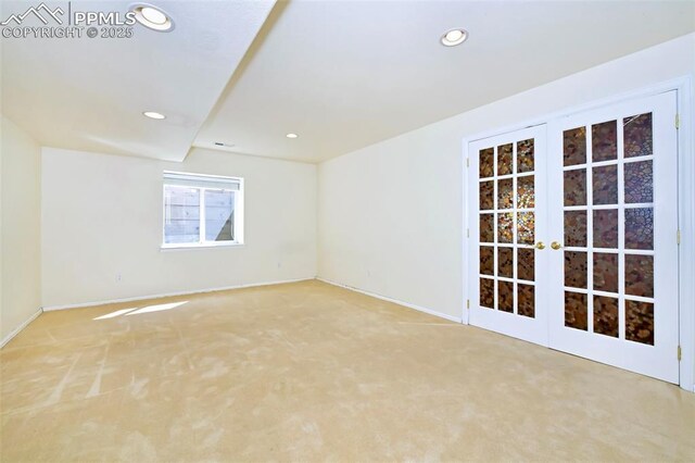 empty room featuring recessed lighting, french doors, and light carpet