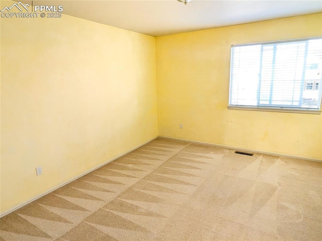 unfurnished room featuring visible vents and carpet floors