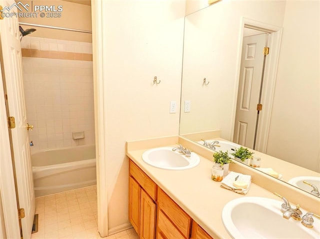 bathroom featuring double vanity, shower / bath combination, and a sink