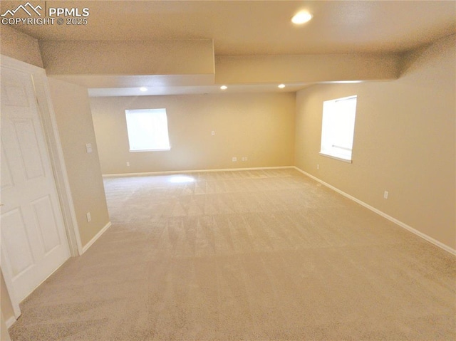 unfurnished room with recessed lighting, baseboards, and light carpet