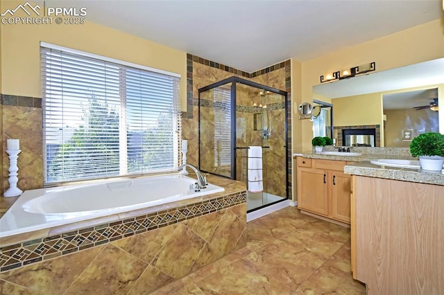 bathroom featuring a bath, a shower stall, vanity, and ceiling fan