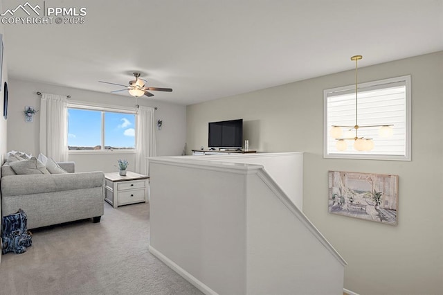 hall featuring baseboards, an upstairs landing, and carpet