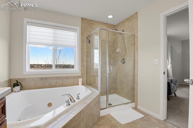 bathroom with tile patterned floors, a tub with jets, a stall shower, and baseboards