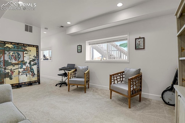 living area featuring visible vents, baseboards, and carpet floors