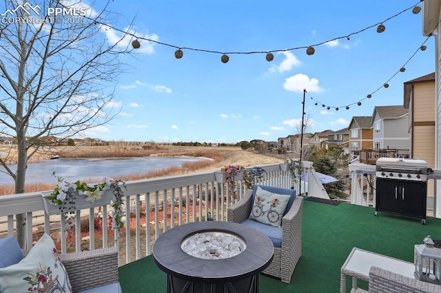 exterior space featuring area for grilling and a water view