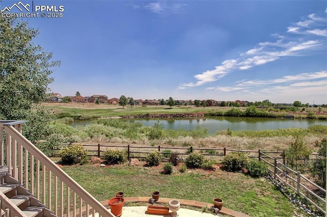 view of yard with fence and a water view