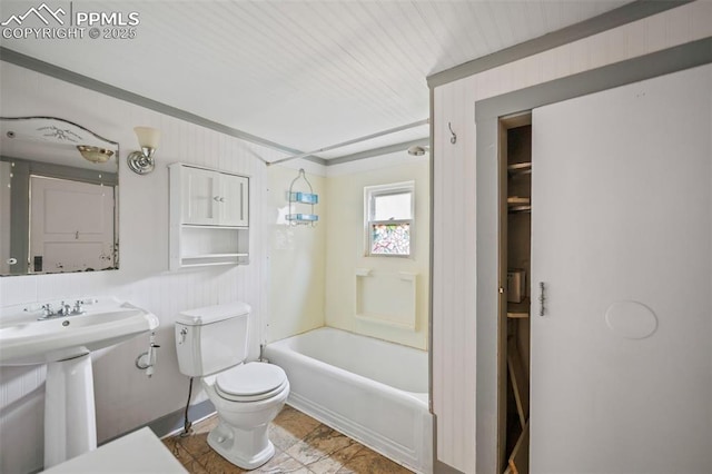 bathroom with shower / washtub combination, a sink, and toilet