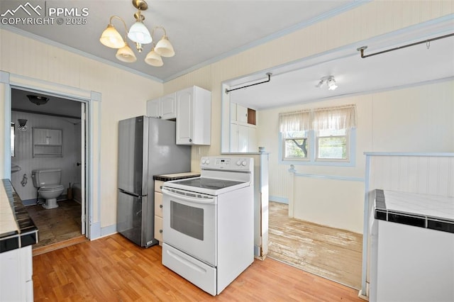 kitchen featuring crown molding, white cabinetry, light wood-style flooring, and electric stove