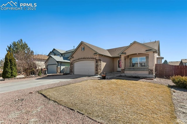 view of front facade with a garage, concrete driveway, fence, and stucco siding