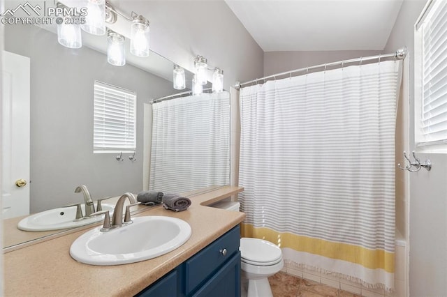 full bath with toilet, vanity, vaulted ceiling, tile patterned floors, and shower / bath combo