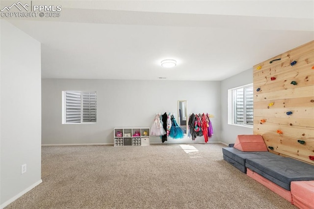 recreation room featuring carpet and baseboards