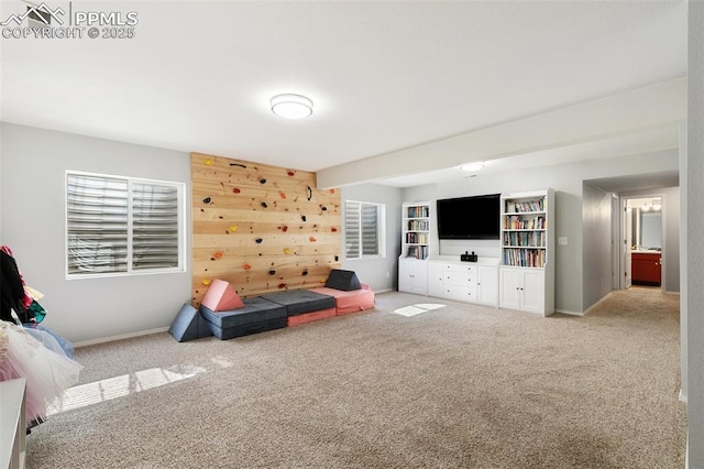 carpeted living area featuring baseboards