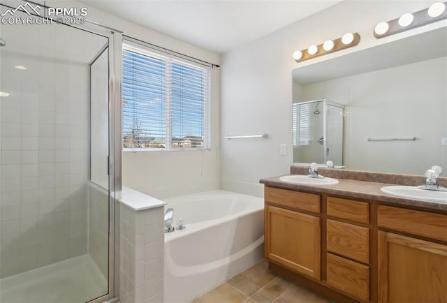 full bathroom featuring a garden tub, double vanity, a stall shower, and a sink