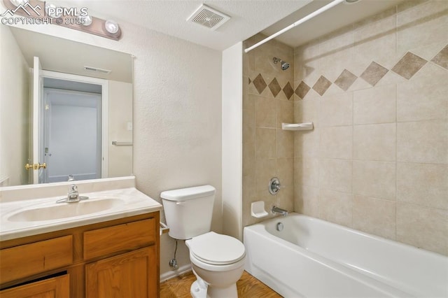 bathroom with toilet, shower / tub combination, vanity, and visible vents