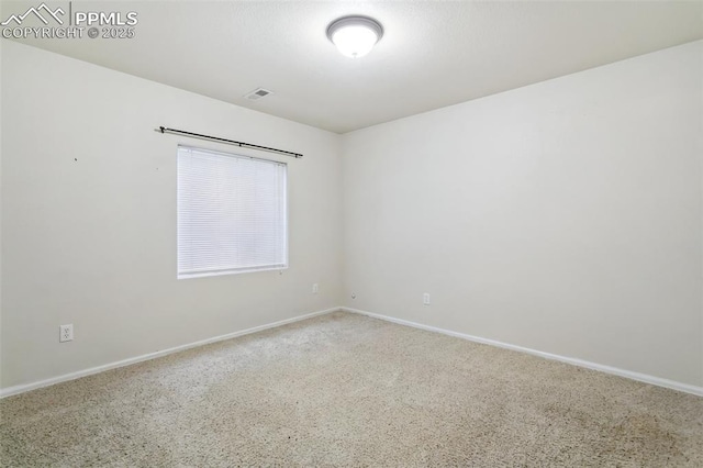 unfurnished room with baseboards, visible vents, and carpet flooring