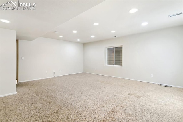 unfurnished room featuring baseboards, carpet flooring, visible vents, and recessed lighting