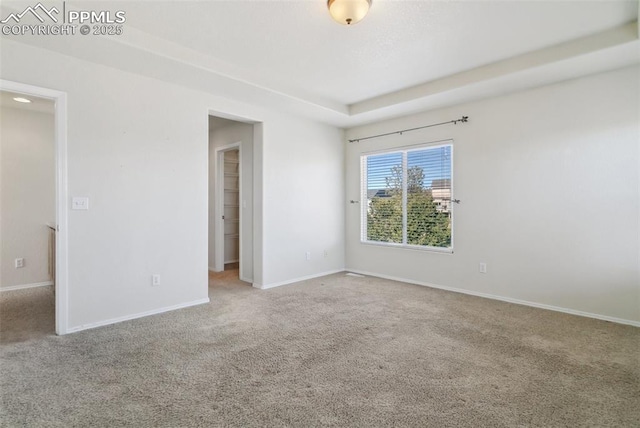 empty room with carpet and baseboards