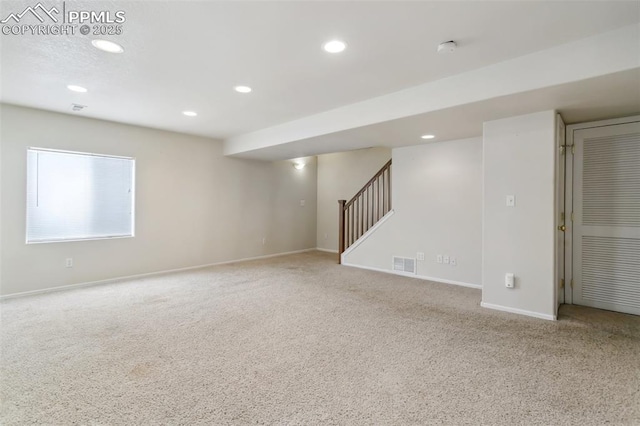 basement featuring recessed lighting, carpet floors, visible vents, baseboards, and stairway