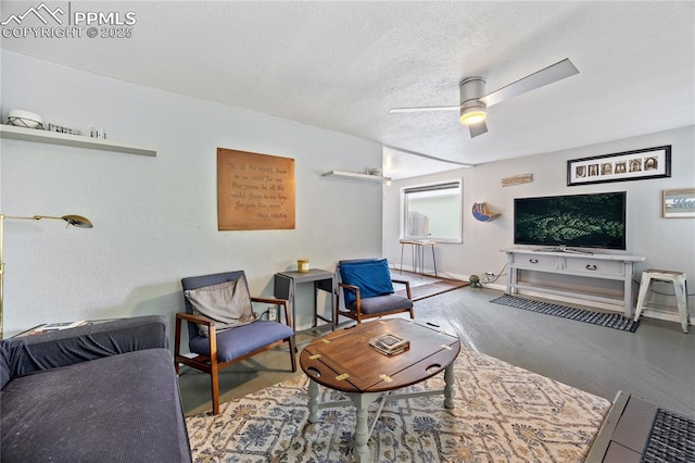 living area featuring a textured ceiling, baseboards, and a ceiling fan