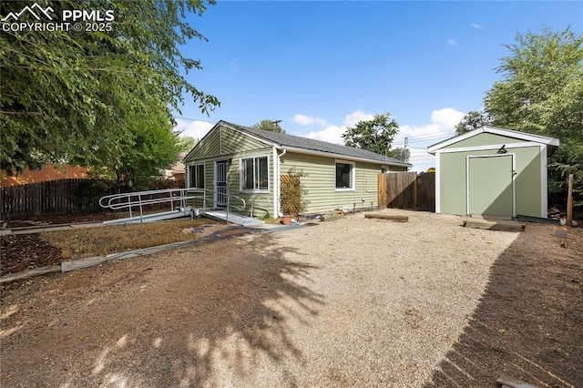 exterior space featuring a shed, an outdoor structure, and fence