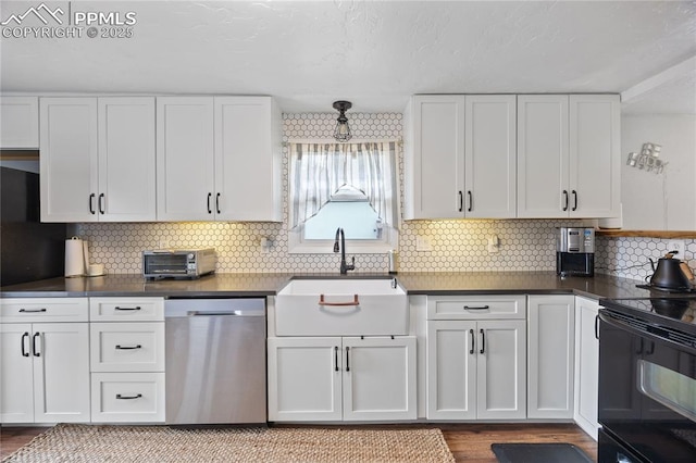 kitchen featuring black / electric stove, a sink, white cabinetry, stainless steel dishwasher, and dark countertops