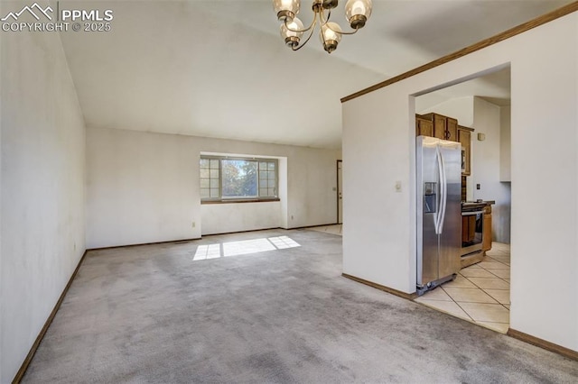 spare room with light tile patterned floors, baseboards, light colored carpet, lofted ceiling, and a notable chandelier