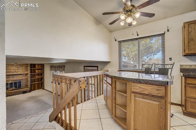 kitchen with a fireplace, light tile patterned floors, open shelves, lofted ceiling, and light colored carpet