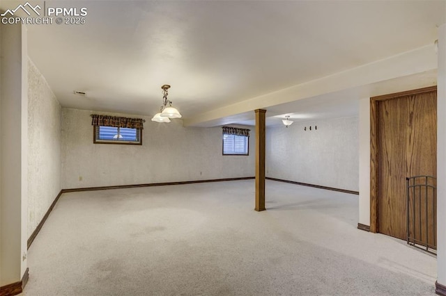 basement featuring wallpapered walls, carpet flooring, and baseboards