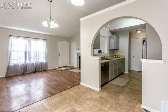 kitchen featuring dishwasher, light countertops, a textured ceiling, gray cabinetry, and a sink