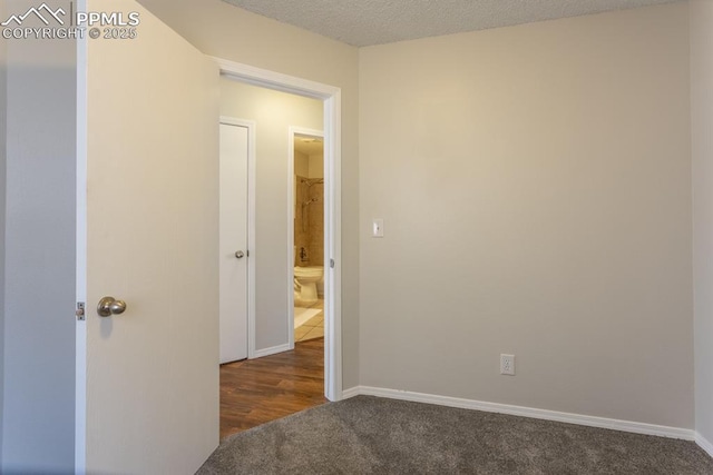 interior space with a textured ceiling and baseboards