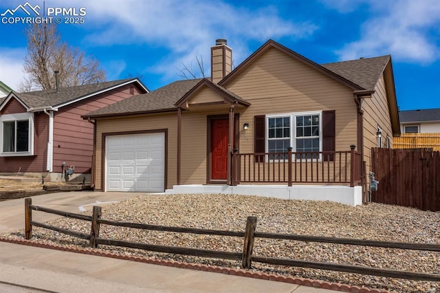 ranch-style house featuring a chimney, a shingled roof, concrete driveway, fence, and a garage