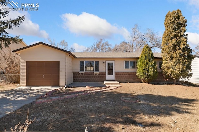 ranch-style home with driveway, brick siding, and an attached garage