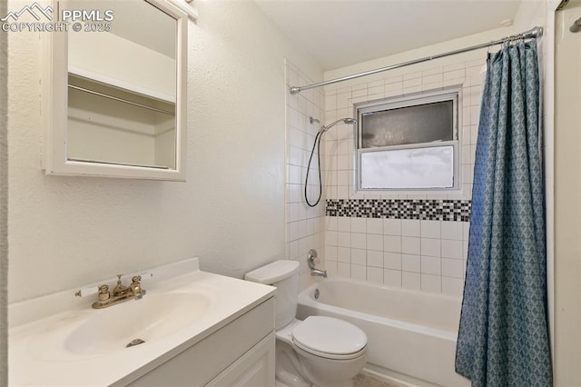 full bathroom featuring a textured wall, shower / tub combo, vanity, and toilet