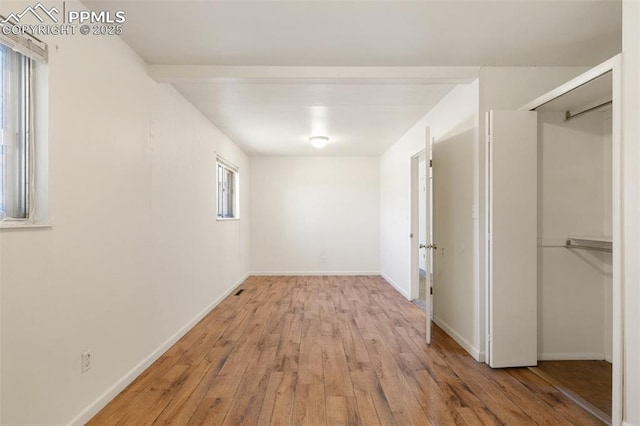 interior space featuring wood finished floors and baseboards