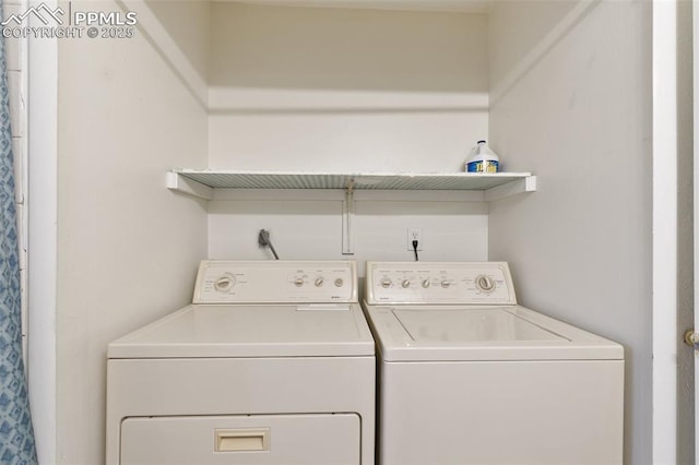 clothes washing area with washer and dryer and laundry area