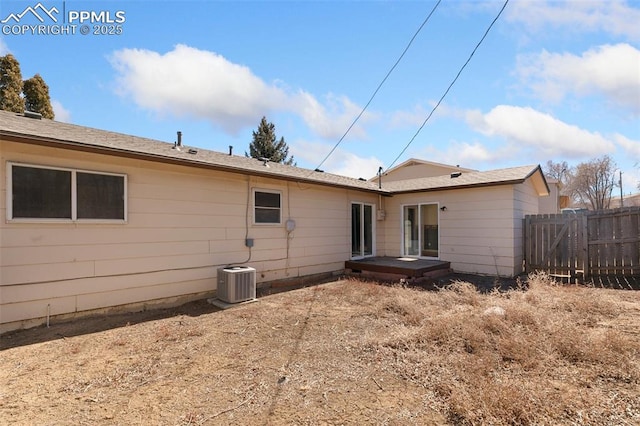 back of house featuring fence and central AC unit