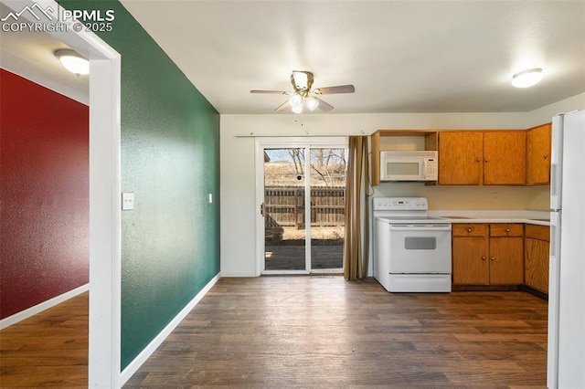 kitchen featuring white appliances, baseboards, dark wood-style floors, brown cabinets, and light countertops