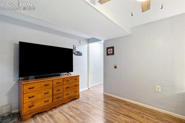4054 Charleston Dr, Colorado Springs, CO 80916 - living room featuring light wood finished floors, baseboards, a ceiling fan, and a textured wall