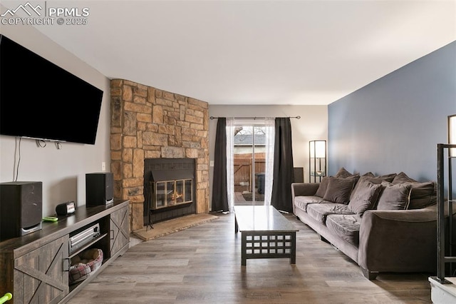 4054 Charleston Dr, Colorado Springs, CO 80916 - living area featuring a stone fireplace and wood finished floors