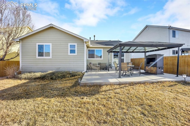 rear view of house featuring a gazebo, a patio area, a lawn, and fence