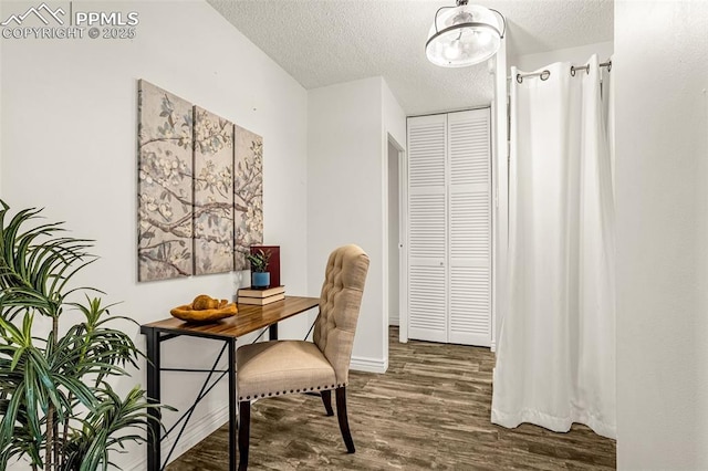 office with a textured ceiling, wood finished floors, and baseboards