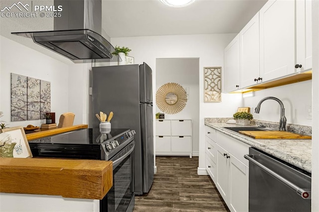 kitchen with white cabinets, wall chimney exhaust hood, stainless steel appliances, and a sink