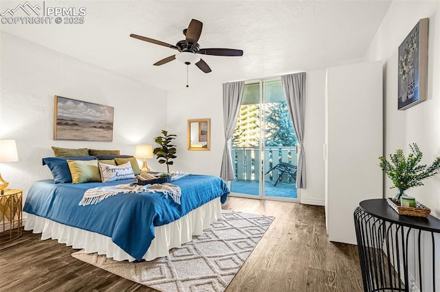 bedroom featuring ceiling fan, wood finished floors, and access to exterior