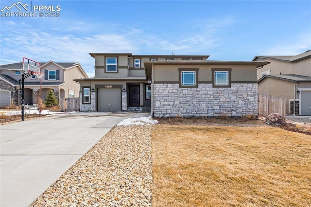 prairie-style home featuring stone siding, driveway, fence, and stucco siding