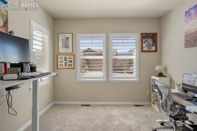 carpeted office with visible vents and baseboards